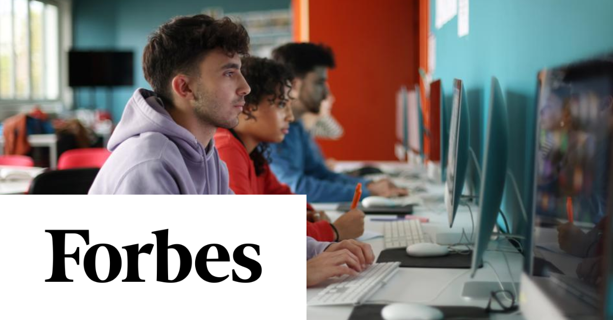 A group of young individuals working on desktop computers in a classroom, with "Forbes" written in bold letters in the foreground.