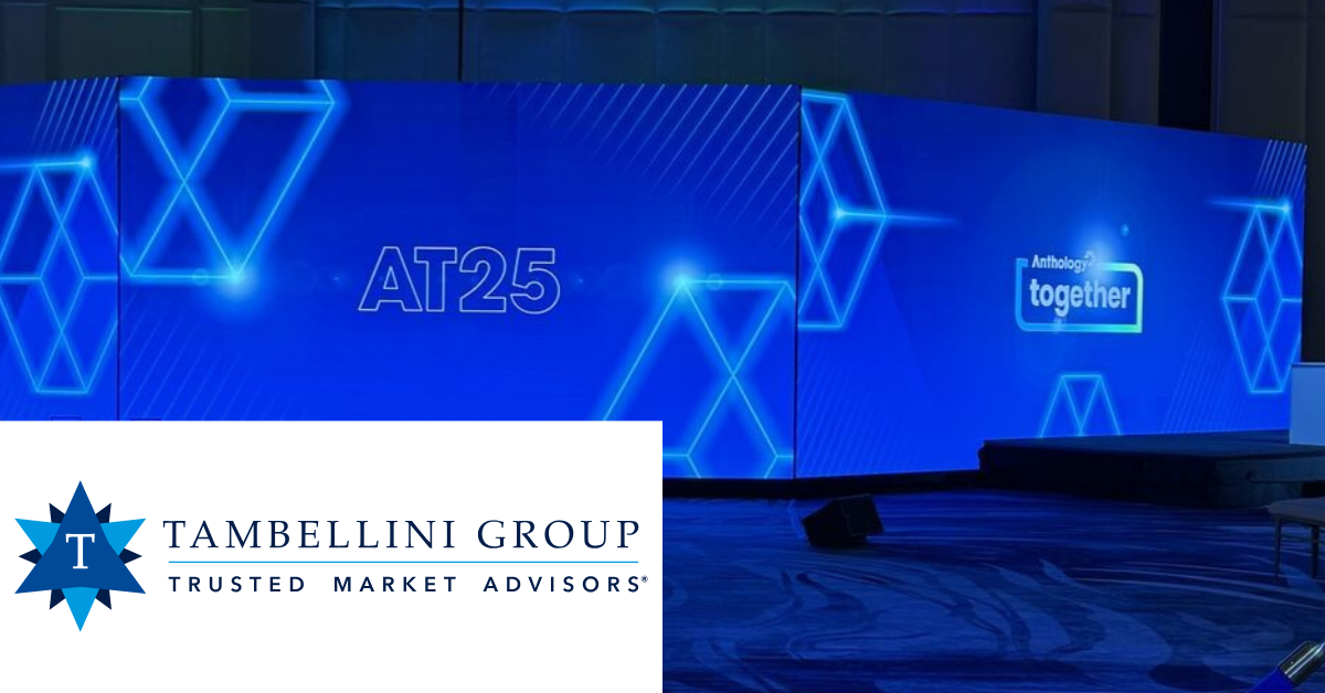 A stage with blue geometric displays and text "AT25" and "Anthology Together," plus Tambellini Group logo below.