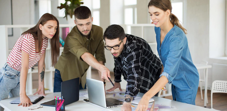 Coworkers collaborating on a laptop