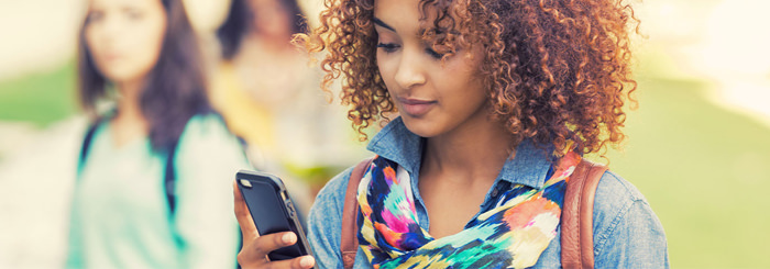 Woman using phone to read resource