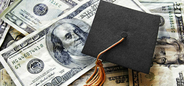 Photo of a graduation cap over US currency