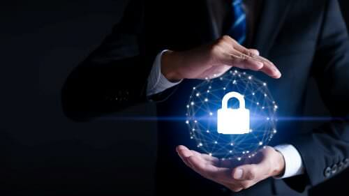 Close up hands around an illustration of a lock representing cyber security