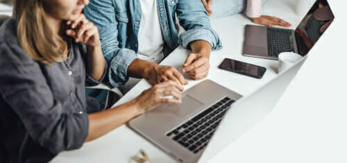 Closer up photo of two people collaborating at a laptop