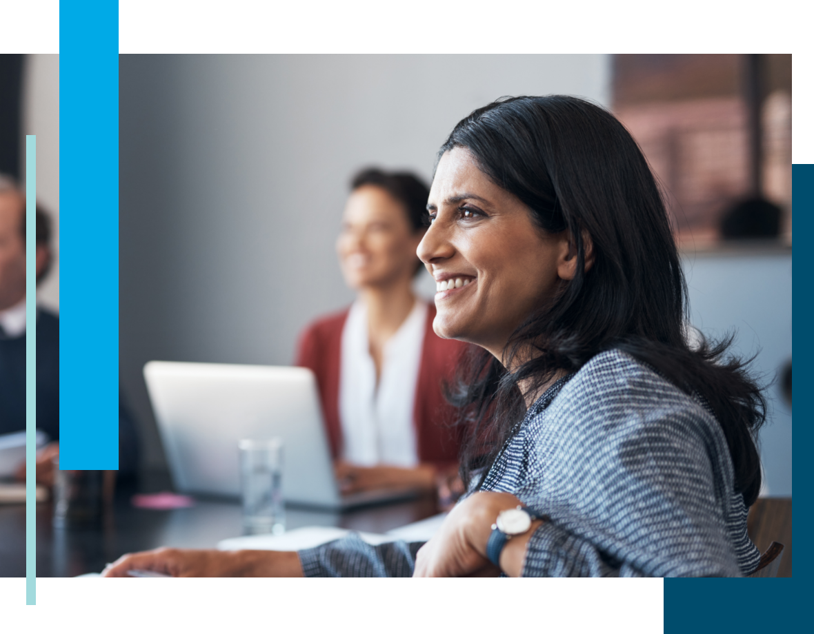 Woman smiling in the workplace while discussing on Anthology planning