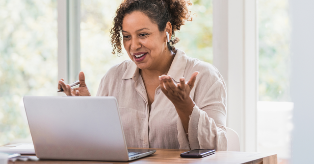 Photo of a woman at a laptop engaged in a webinar