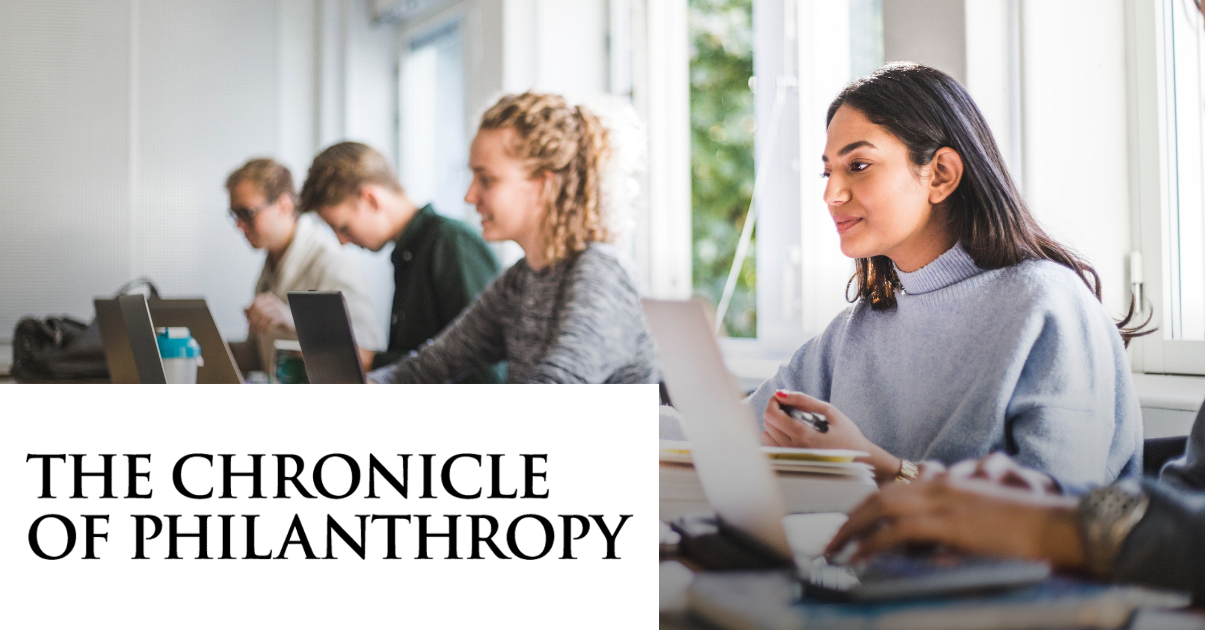 Image of some students working with laptops with the The Chronicle of Philanthropy logo placed on the left lower corner.