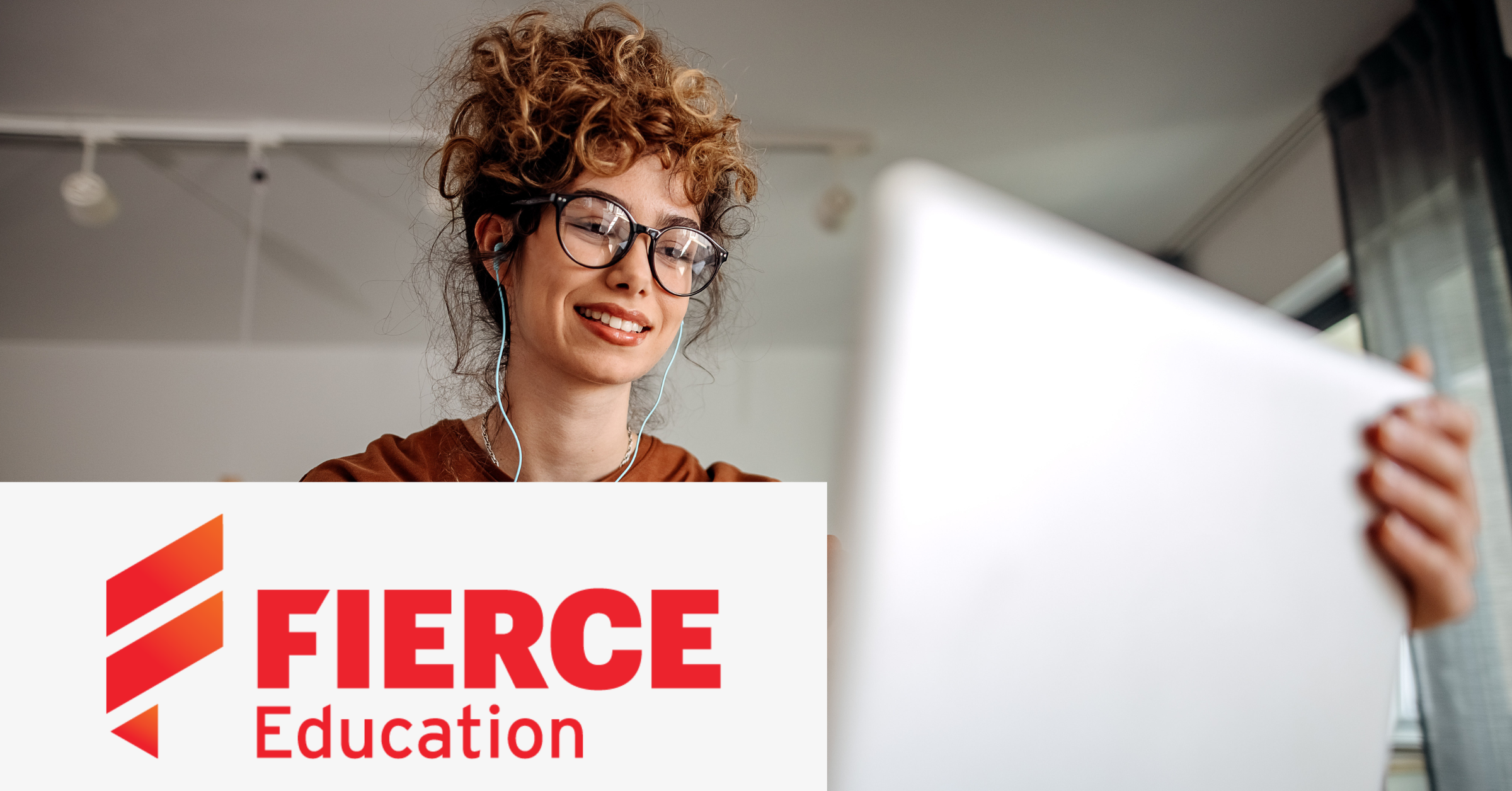 Image with the Fierce Education logo on the lower left corner and a picture of a woman using a laptop as a background.