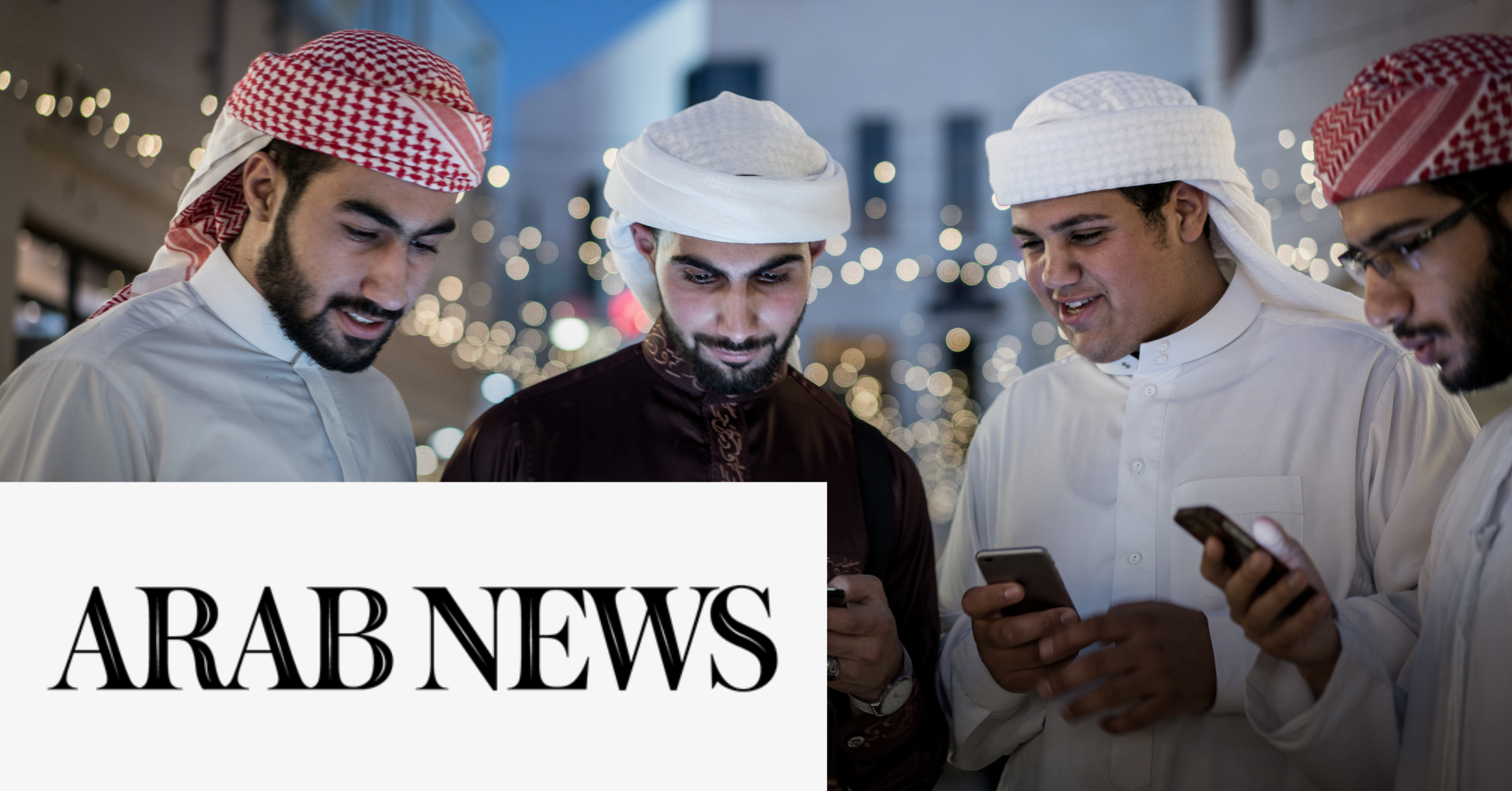 Image of four Arab men checking their mobile phones with the Arab News logo on the lower left corner of the graphic.