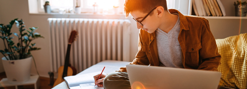 Photo of a student working at their laptop