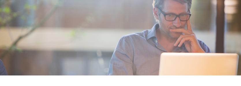 Photo of a man working at a laptop