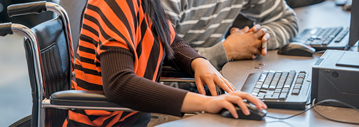 wheelchair-bound student using computer for class access
