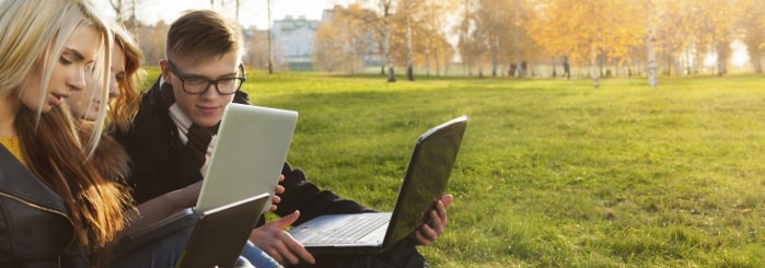 students watching webinar on laptop outside